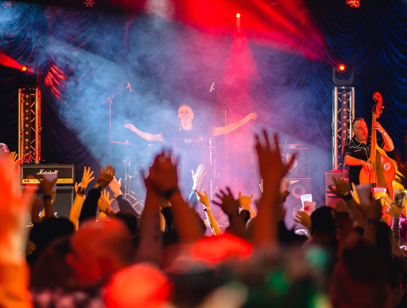 View through the crowd of a band on stage at the Incider Festival, Sand Bay, Weston-super-Mare